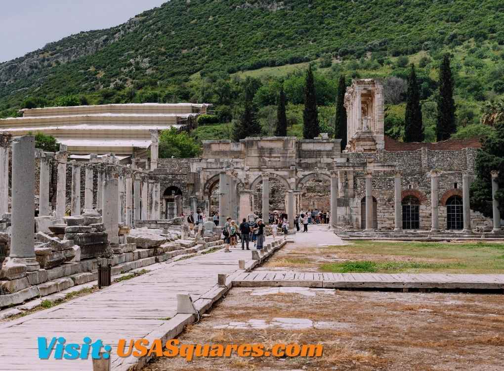 Ancient ruins with visitors exploring a historical site surrounded by lush greenery. Discover more about historical locations at onthisveryspots.com/