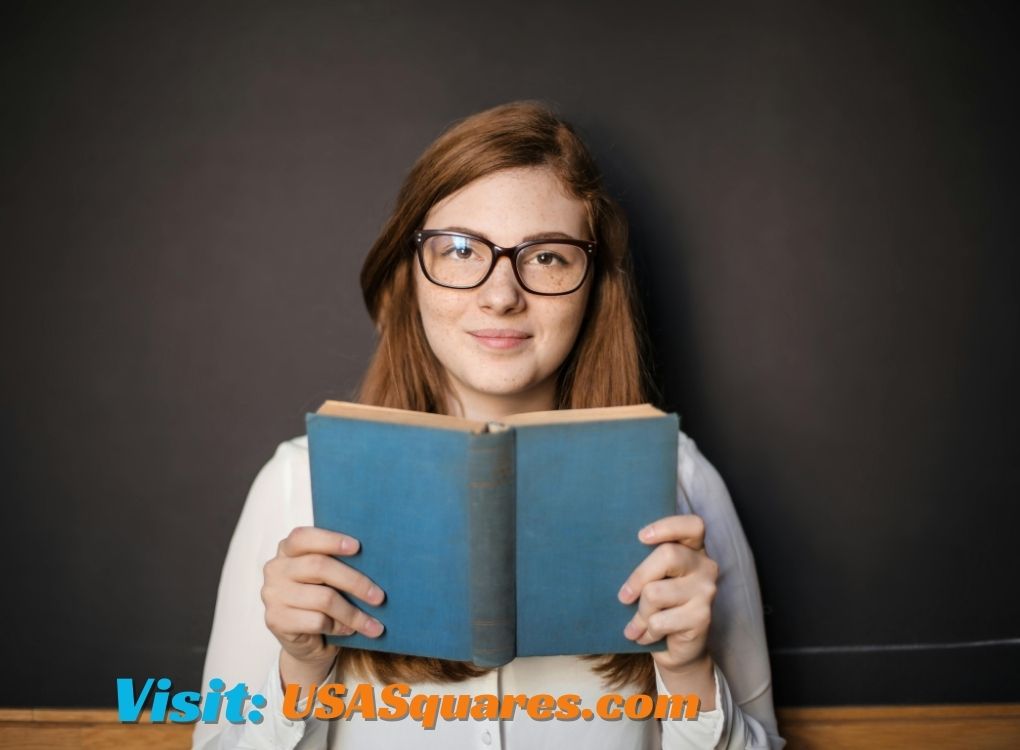 A young girl holding an open book, symbolizing the importance of literacy of females in Israel.